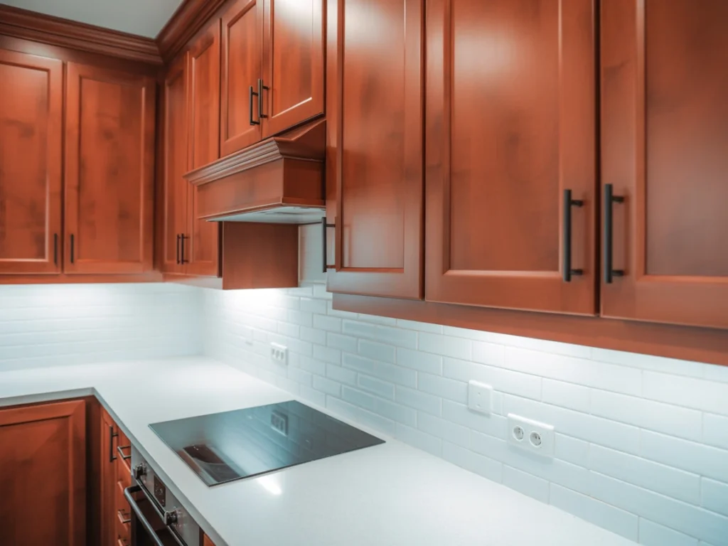 Cherry cabinets with black, gold, and bronze hardware finishes, highlighting which colors create the strongest visual contrast.